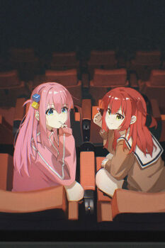  2girls absurdres blue_eyes bocchi_the_rock! brown_sweater candy chinese_commentary choppy_bangs closed_mouth commentary expressionless film_grain food from_behind gotoh_hitori hair_between_eyes hand_up heavy_film_grain highres holding holding_candy holding_food holding_lollipop indoors jacket kita_ikuyo lollipop lollipop_in_mouth long_bangs long_hair long_sleeves looking_at_viewer looking_back movie_theater multiple_girls pink_hair pink_jacket sailor_collar school_uniform serafuku shuka_high_school_uniform sleeves_past_wrists smile split_mouth summerwood_000 sweater track_jacket white_sailor_collar yellow_eyes 