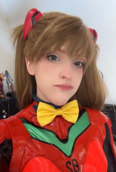  1girl blue_eyes bodysuit bow brazilian_(nationality) breasts brown_hair cosplay hairpods highres indoors interface_headset_(evangelion) lips looking_at_viewer mecha_pilot_suit medium_breasts memepantazis neon_genesis_evangelion photo_(medium) plugsuit_(evangelion) red_bodysuit shiny_clothes solo souryuu_asuka_langley souryuu_asuka_langley_(cosplay) twintails twitter_username two_side_up yellow_bow 