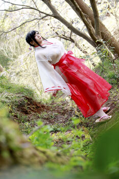  1girl asian bikini black_hair breasts chouzuki_maryou highres japanese_clothes large_breasts lipstick makeup miko photo_(medium) plump see-through_clothes skirt solo swimsuit 