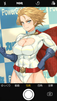  1girl belt blonde_hair blue_eyes breasts camera_phone cape cleavage commentary_request dc_comics hands_on_own_hips large_breasts mikoyan power_girl short_hair turtleneck 