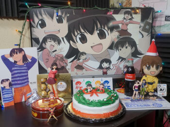  1girl 2d_dating azumanga_daioh's_school_uniform azumanga_daiou blue_shirt bottle cake card chocolate christmas christmas_cake christmas_lights coca-cola english_text ferrero_rocher figure food hewlett_packard highres japanese_clothes kimono long_sleeves monitor orange_pants pants photo_(medium) playing_card school_uniform shirt shrine soda_bottle solo stuffed_toy takino_tomo yellow_kimono 