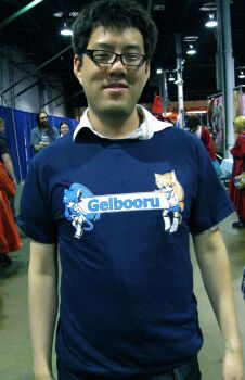  2girls 4boys absurdres albert_yi animal_ears anime_central asian belt black-framed_eyewear black_hair blonde_hair blue_eyes blue_hair blue_shirt buttons cat_ears cat_girl cat_tail cheating_(relationship) costume cowboy_shot crooked_eyewear crossed_arms crossover danbooru_(site) denim dress dressing_room epic gelbooru glasses highres indoors lamp long_hair looking_at_viewer male_focus manly meta multiple_boys multiple_girls netorare otaku parted_lips photo_(medium) ponytail real_life red_dress security_camera shirt short_hair short_sleeves shorts smile smug solo_focus t-shirt tail teeth very_long_hair white_dress white_shirt  rating:General score:213 user:lozertuser