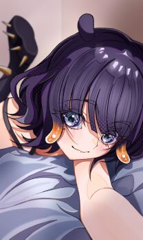  1girl absurdres black_boots blue_eyes boots closed_mouth gradient_hair gummy_candy_93 highres hololive hololive_english looking_at_viewer lying mole mole_under_eye multicolored_hair ninomae_ina'nis on_stomach orange_hair purple_hair solo spiked_boots tentacle_hair virtual_youtuber 