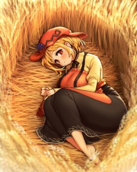  1girl absurdres aki_minoriko apron barefoot black_skirt breasts closed_mouth curvy full_body grape_hat_ornament hat highres ichika_(ichika_manga) juliet_sleeves large_breasts long_skirt long_sleeves looking_at_viewer lying no_pupils on_side plantar_flexion puffy_sleeves red_apron red_eyes red_hat shirt skirt solo touhou wheat_field yellow_shirt 