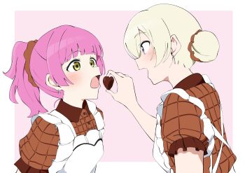  2girls absurdres apron blonde_hair blunt_bangs blush border brown_dress candy chocolate chocolate_heart dress feeding food frilled_apron frilled_dress frilled_sleeves frills hair_bun heart heart-shaped_food heart_apron highres love_live! love_live!_nijigasaki_high_school_idol_club medium_hair mia_taylor multiple_girls open_mouth outside_border pink_background pink_hair ponytail puffy_short_sleeves puffy_sleeves purple_eyes short_hair short_sleeves sidelocks simple_background single_hair_bun smile tennoji_rina uchuu_no_mozuku upper_body white_apron white_border yellow_eyes 