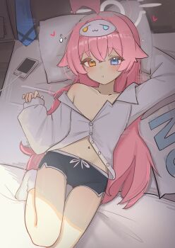  1girl absurdres ahoge alternate_costume black_shorts blue_archive blue_eyes cellphone collarbone dolphin_shorts flat_chest halo heterochromia high_(hgih) highres hoshino_(blue_archive) loli long_hair long_sleeves looking_at_viewer lying navel on_back orange_eyes parted_lips phone pillow pink_hair pink_halo puffy_long_sleeves puffy_sleeves shirt short_shorts shorts single_bare_shoulder socks solo white_socks yes-no_pillow 