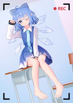  1girl :p absurdres barefoot blue_bow blue_dress blue_eyes blue_hair blue_necktie blush bow chair chinese_commentary cirno closed_mouth collared_shirt commentary_request desk detached_wings dress hair_bow highres ice ice_wings long_sleeves looking_at_viewer medium_hair necktie on_desk one_eye_closed pinafore_dress pointy_ears recording school_chair school_desk shirt sitting sleeveless sleeveless_dress smile solo toes tongue tongue_out touhou viewfinder white_shirt wings wrainman 