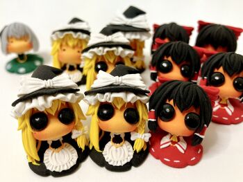  3girls apron ascot black_hair black_hat black_skirt black_vest blonde_hair blurry blush bow braid clone commentary_request depth_of_field detached_sleeves figure_(medium) green_skirt grey_hair hair_tubes hakurei_reimu hat hat_bow highres kirisame_marisa konpaku_youmu looking_at_viewer medium_hair multiple_girls neriko_nerineri own_hands_together photo_(medium) puffy_short_sleeves puffy_sleeves red_bow red_shirt red_skirt ribbon-trimmed_skirt ribbon_trim shirt short_sleeves sidelocks single_braid skirt sleeveless sleeveless_shirt solid_eyes touhou vest waist_apron white_bow white_shirt wide_sleeves witch_hat yellow_ascot 