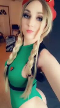 1girl animated ass bare_shoulders blonde_hair blue_eyes braid breasts cammy_white cammy_white_(cosplay) cosplay hat jenifer_ann large_breasts leotard looking_at_viewer real_life sleeveless street_fighter tagme thigh_strap thong_leotard tongue tongue_out video