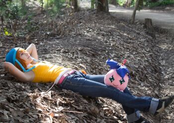 Rule 34 | 1girl, belt, blue helmet, cosplay photo, denim, digimon, digimon adventure, helmet, japanese (nationality), jeans, orange hair, pants, photo (medium), pink belt, real life, stuffed toy, takenouchi sora, tree, vest, winrockbell, yellow vest