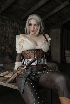 alina_becker belt breasts ciri ciri_(cosplay) clothes cosplay female_focus gloves green_eyes highres holster holstered looking_at_viewer medium_breasts model photo_(medium) scar scar_across_eye scar_on_face solo sword the_witcher_(series) weapon white_hair