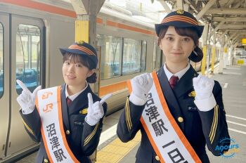 2girls costume furihata_ai gloves hat komiya_arisa looking_at_viewer multiple_girls outdoors photo_(medium) smile standing train train_conductor train_station v voice_actor watermark white_gloves