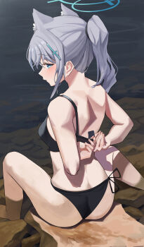 1girl absurdres adjusting_clothes adjusting_swimsuit animal_ears aqua_eyes ass back bikini black_bikini blue_archive blush commentary cross_hair_ornament extra_ears from_behind grey_hair hair_ornament halo highres looking_at_viewer medium_hair nape nishida_yuuto outdoors ponytail rock shiroko_(blue_archive) sidelocks sitting soaking_feet solo swimsuit thighs water wolf_ears wolf_girl