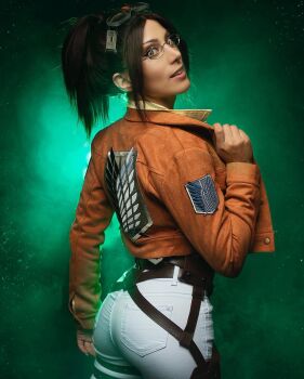 1girl adjusting_eyewear ass brown_hair brown_jacket collared_jacket cosplay cosplay_photo elizabeth_rage female_focus glasses hange_zoe hange_zoe_(cosplay) highres jacket looking_at_viewer looking_back military_jacket open_clothes open_jacket paradis_military_uniform parted_bangs photo_(medium) ponytail real_life shingeki_no_kyojin solo survey_corps_(emblem)