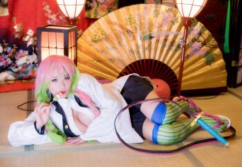 1girl braid breasts cleavage cosplay female_focus gradient_hair highres holding holding_sword holding_weapon japanese_(nationality) kanroji_mitsuri kanroji_mitsuri_(cosplay) kimetsu_no_yaiba large_breasts looking_at_viewer lying model multicolored_hair open_mouth photo_(medium) real_life shibuya_kaho smile solo sword tongue tongue_out twin_braids twintails weapon