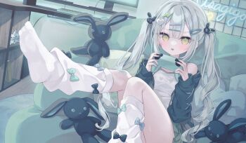 1girl black_jacket camisole closed_mouth commentary computer_keyboard computer_mouse controller english_commentary game_controller green_eyes green_skirt grey_hair hair_ornament hairclip hands_up heart heart_hair_ornament highres holding holding_controller holding_game_controller hoshi_(snacherubi) indoors jacket knees_together_feet_apart lightning_bolt lightning_bolt_hair_ornament lightning_bolt_symbol long_hair long_sleeves looking_at_viewer loose_socks monitor no_shoes off_shoulder open_clothes open_jacket original pixelated pleated_skirt puffy_long_sleeves puffy_sleeves rabbit_hair_ornament skirt sleeves_past_wrists socks soles solo stuffed_animal stuffed_rabbit stuffed_toy tongue tongue_out twintails very_long_hair white_camisole white_socks