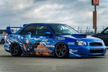 1girl amd apex_legends belt black_choker black_shirt blue_belt blue_eyes blue_hair bow car character_name choker cloud crossed_legs earrings electronic_arts green_bow hair_behind_ear hand_on_own_knee highres hololive hoshimachi_suisei hoshimachi_suisei_(casual) itasha jewelry logo long_hair micro_star_international moonbell motor_vehicle official_alternate_costume one_side_up orange_nails photo_(medium) ring shirt sky sleeveless sleeveless_shirt solo spoiler_(automobile) sponsor stance_(vehicle) subaru_(brand) subaru_impreza vehicle_focus virtual_youtuber youtube