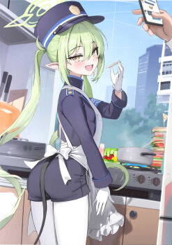 1girl apron armband ass blue_archive blush breasts cellphone demon_tail gloves green_hair halo hat highres houraku kitchen long_hair long_sleeves looking_at_viewer looking_back nozomi_(blue_archive) open_mouth peaked_cap phone pointy_ears smile solo_focus stove tail thighs twintails white_apron yellow_eyes