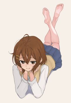 1girl ahoge andreypavlow bare_legs barefoot blue_skirt blush brown_eyes brown_hair closed_mouth crossed_ankles crossed_bangs feet feet_up full_body grey_background hair_between_eyes hair_ornament hairclip highres hirasawa_yui k-on! long_sleeves looking_at_viewer lying medium_hair miniskirt on_stomach sakuragaoka_high_school_uniform school_uniform shadow simple_background skirt smile soles solo the_pose toes