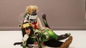 2girls animated asui_tsuyu asui_tsuyu_(cosplay) asui_tsuyu_(hero_outfit) blonde_hair bodysuit boku_no_hero_academia cosplay green_bodysuit multiple_girls neckerchief real_life red_neckerchief school_uniform serafuku sound spanking tagme toga_himiko toga_himiko_(cosplay) video