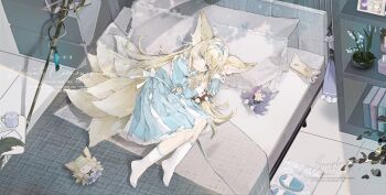 1girl absurdres animal_ears arknights blonde_hair character_doll chinese_commentary commentary_request dokomdokom doll fox_ears fox_tail highres kitsune kyuubi lying multiple_tails on_side partial_commentary pillow socks solo suzuran&#039;s_father_(arknights) suzuran_(arknights) tail vulpisfoglia_(arknights) white_socks