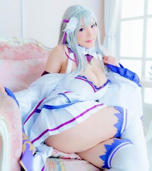 1girl breasts cosplay emilia_(re:zero) emilia_(re:zero)_(cosplay) female_focus highres large_breasts long_hair looking_at_viewer model photo_(medium) pointy_ears purple_eyes re:zero_kara_hajimeru_isekai_seikatsu shibuya_kaho sitting solo white_hair