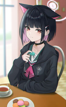 1girl absurdres animal_ears bad_id bad_pixiv_id black_choker black_hair black_hoodie blue_archive blunt_bangs chair choker closed_mouth collarbone colored_inner_hair cup extra_ears food halo highres holding holding_food hood hood_down hoodie indoors kazusa_(blue_archive) kit long_sleeves looking_at_viewer macaron multicolored_hair pink_hair plate red_eyes short_hair sitting sleeves_past_wrists smile solo table tea teacup upper_body