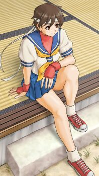 1girl blue_sailor_collar breasts brown_eyes brown_hair closed_mouth commentary_request converse fingerless_gloves from_above full_body gloves headband highres kasugano_sakura mma_gloves neckerchief red_sports_bra sailor_collar sailor_crest school_uniform serafuku shoes short_hair sitting skirt smile solo sports_bra street_fighter street_fighter_zero_(series) white_headband x_chitch