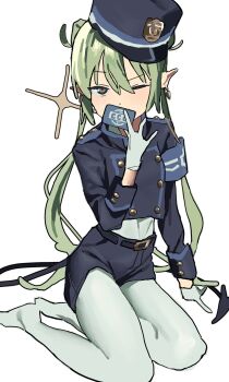 1girl armband azalaxy belt blue_archive blue_hat blue_shorts card covering_own_mouth demon_tail earrings gloves green_hair hat highres holding jacket jewelry long_hair long_sleeves looking_at_viewer nozomi_(blue_archive) one_eye_closed pantyhose pointy_ears police_hat shorts simple_background sitting solo tail twintails white_background white_gloves white_pantyhose yokozuwari