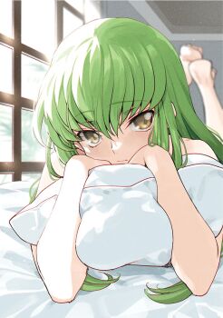 1girl barefoot c.c. closed_mouth code_geass creayus day green_hair hair_spread_out hugging_object indoors long_hair looking_at_viewer lying on_stomach pillow pillow_hug solo sunlight window yellow_eyes