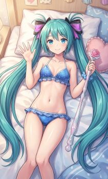 aqua_hair bikini blue_bikini blue_eyes blush commentary flower frilled_bikini frills green_hair groin hair_ribbon hatsune_miku heart heart-shaped_pillow lamp legs light_smile looking_at_viewer on_bed pillow ribbon smile staff swimsuit vocaloid waving