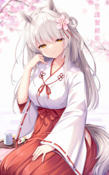 1girl animal_ears blurry blurry_background branch breasts brown_eyes chinese_zodiac closed_mouth commentary_request cup dango depth_of_field flower food grey_hair hair_between_eyes hair_flower hair_ornament hakama hakama_skirt half-closed_eyes hand_up highres horse_ears horse_girl horse_tail japanese_clothes kimono large_breasts long_hair looking_at_viewer nengajou new_year original pink_flower red_hakama sanshoku_dango seiza sitting skirt smile solo tail translation_request tray umitonakai wagashi white_kimono year_of_the_horse yunomi