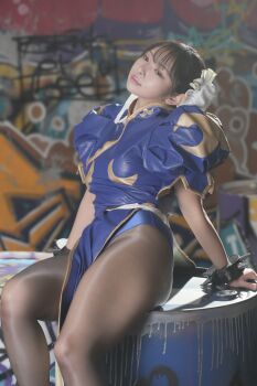 1girl asian blue_dress brown_pantyhose capcom china_dress chinese_clothes chun-li chun-li_(cosplay) cosplay cosplay_photo dress female_focus hair_bun pantyhose photo_(medium) purin_cosplay real_life solo street_fighter thighs
