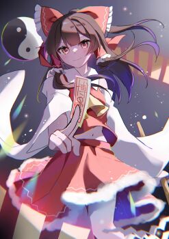 1girl alt_text ascot between_fingers bow brown_hair closed_mouth commentary_request detached_sleeves frilled_bow frilled_hair_tubes frills gohei hair_bow hair_tubes hakurei_reimu hidukihumi highres holding holding_gohei long_hair looking_at_viewer midriff_peek navel ofuda ofuda_between_fingers orb red_bow red_eyes red_skirt skirt skirt_set smile solo touhou yellow_ascot yin_yang yin_yang_orb