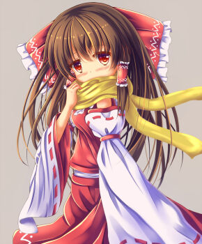 1girl adjusting_scarf arm_at_side blush bow breasts brown_hair commentary_request covered_mouth cowboy_shot detached_sleeves frilled_bow frilled_hair_tubes frills grey_background hair_bow hair_tubes hakurei_reimu hand_up long_hair long_sleeves looking_at_viewer medium_breasts red_bow red_eyes red_ribbon red_skirt red_vest ribbon ribbon-trimmed_sleeves ribbon_trim scarf scarf_over_mouth simple_background skirt sleeve_ribbon solo standing touhou unory vest white_sleeves wide_sleeves yellow_scarf