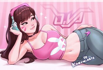 1girl animal_print artist_name breasts brown_eyes brown_hair character_name cleavage closed_mouth commentary d.va_(overwatch) eyebrows_hidden_by_hair facial_mark hand_on_own_hip head_rest headphones highres konomidraws large_breasts long_hair looking_to_the_side midriff navel overwatch pants pink_shirt rabbit_print shirt smile solo sparkle symbol-only_commentary