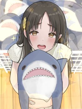 1girl blurry blurry_background blush brown_eyes brown_hair commentary_request from_above gakuen_idolmaster hair_ornament highres holding holding_stuffed_toy idolmaster ikea_shark kuramoto_china long_hair looking_at_viewer open_mouth parted_bangs pleading_eyes shirt slime_senpai smile solo sparkle sparkling_eyes straight_hair stuffed_animal stuffed_shark stuffed_toy teeth upper_teeth_only white_shirt wooden_floor