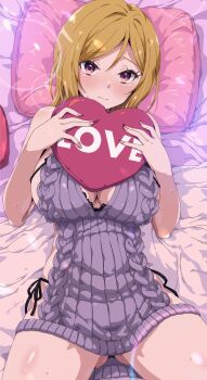 1girl bed black_panties blonde_hair blush breasts character_request cleavage clothing_request commentary commission english_commentary english_text furrowed_brow gluteal_fold heart heart-shaped_pillow highres holding large_breasts oomura_karasu original panties pillow pink_nails pink_pillow purple_shirt shirt solo string_panties sweat underwear