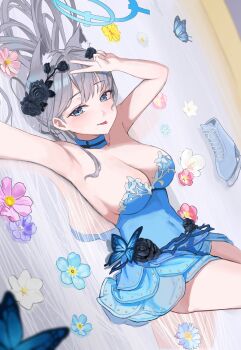 1girl :p absurdres animal_ears arm_up bare_shoulders black_flower blue_archive blue_butterfly blue_dress blue_halo blush breasts bug butterfly cleavage closed_mouth commentary covered_navel dress flower grey_eyes grey_hair hair_flower hair_ornament halo hand_up heterochromia highres ice_skates insect large_breasts long_hair looking_at_viewer lying on_back pink_flower pongdo purple_flower reflection shiroko_(blue_archive) shoes skates solo strapless strapless_dress tongue tongue_out unworn_shoes v very_long_hair white_flower wolf_ears yellow_flower