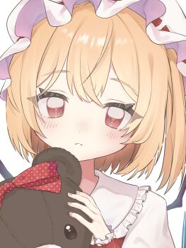 1girl absurdres blonde_hair blush commentary doll fingernails flandre_scarlet frilled_hat frilled_sailor_collar frilled_wristband frills hat highres holding holding_doll kuusou_gumi looking_at_viewer mob_cap one_side_up red_eyes sailor_collar short_hair simple_background solo stuffed_animal stuffed_toy teddy_bear touhou upper_body white_background white_hat wings