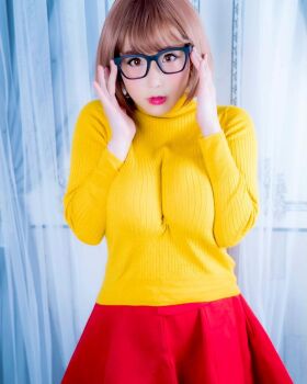 1girl breasts brown_eyes brown_hair cosplay female_focus glasses highres large_breasts looking_at_viewer medium_hair model photo_(medium) scooby-doo shibuya_kaho solo velma_dinkley velma_dinkley_(cosplay) wig