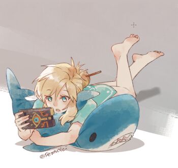 1boy barefoot blue_eyes blue_tunic bottomless commentary crossed_ankles english_commentary hair_bun holding ikea_shark link looking_at_object lying male_focus natsuyon nintendo on_stomach open_mouth parted_bangs sheikah_slate short_sleeves single_hair_bun solo stuffed_animal stuffed_shark stuffed_toy the_legend_of_zelda the_legend_of_zelda:_breath_of_the_wild tunic twitter_username