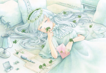 1girl artist_name bow carpet chiori_n closed_eyes clover colored_pencil_(medium) commentary_request dress envelope flower four-leaf_clover hair_bow head_wreath highres holding lamp letter long_hair lying on_back original painting_(medium) paper pen pillow ribbon solo traditional_media twitter_username white_dress white_hair