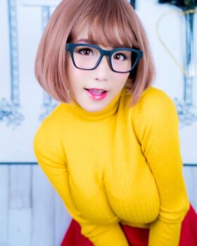 1girl breasts brown_eyes brown_hair cosplay female_focus glasses highres large_breasts looking_at_viewer medium_hair model photo_(medium) scooby-doo shibuya_kaho solo velma_dinkley velma_dinkley_(cosplay) wig