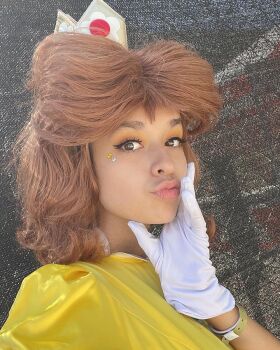 brown_eyes brown_hair cosplay crown dark-skinned_female dark_skin gloves highres lips looking_at_viewer mario_(series) nintendo photo_(medium) princess_daisy princess_daisy_(cosplay) real_life