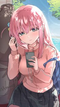 1girl aqua_eyes bocchi_the_rock! breasts cellphone choppy_bangs closed_mouth commentary_request cowboy_shot cube_hair_ornament dappled_sunlight day earbuds earphones gotoh_hitori grey_skirt hair_between_eyes hair_ornament highres holding holding_phone jacket large_breasts light_smile long_bangs long_hair long_sleeves outdoors phone pink_hair plaid_clothes plaid_skirt sidelocks skirt smartphone solo standing sunlight thigh_strap track_jacket wano_(azayakam)