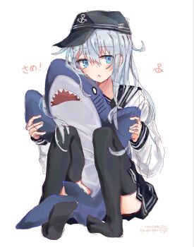 1girl anchor_symbol ass black_hat black_sailor_collar black_skirt black_thighhighs blue_eyes blue_hair blush commentary_request feet flat_cap full_body hair_between_eyes hat hat_pin hibiki_(kancolle) highres holding holding_stuffed_toy kantai_collection knees_up long_hair long_sleeves looking_at_viewer miniskirt open_mouth pleated_skirt r_you_yabai sailor_collar sidelocks signature simple_background sitting skirt solo stuffed_animal stuffed_shark stuffed_toy thighhighs thighs twitter_username white_background
