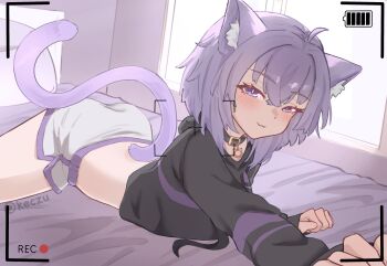 1girl absurdres animal_collar animal_ears bedroom black_hoodie blush cat_ears cat_girl cat_tail closed_mouth collar commentary day dusiacat english_commentary feet_out_of_frame highres hololive hood hood_down hoodie indoors looking_at_viewer lying nekomata_okayu nekomata_okayu_(1st_costume) on_bed on_stomach pillow reaching reaching_towards_viewer recording seductive_smile short_hair shorts smile solo sunlight tail tail_raised twitter_username viewfinder virtual_youtuber white_shorts window