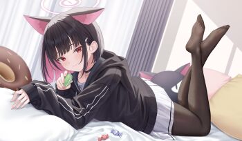 1girl absurdres animal_ears black_choker black_hair black_hoodie black_pantyhose blue_archive blunt_bangs blush candy cat_choker cat_ears cat_girl choker closed_mouth colored_inner_hair commentary food halo highres holding holding_food hood hood_down hoodie kazusa_(blue_archive) legs_up long_sleeves looking_at_viewer lying macaron multicolored_hair no_shoes on_bed on_stomach pantyhose pillow pink_hair pink_halo pleated_skirt rama_(yu-light8) red_eyes short_hair skirt smile solo the_pose white_skirt wrapped_candy
