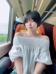 1girl animated asian bare_shoulders black_hair bra bra_peek breasts breasts_squeezed_together cleavage clothes_pull highres leaning_forward looking_at_viewer medium_breasts off_shoulder parted_lips real_life short_hair sitting smile solo sound sumire_live tagme teeth train twitter_username underwear video